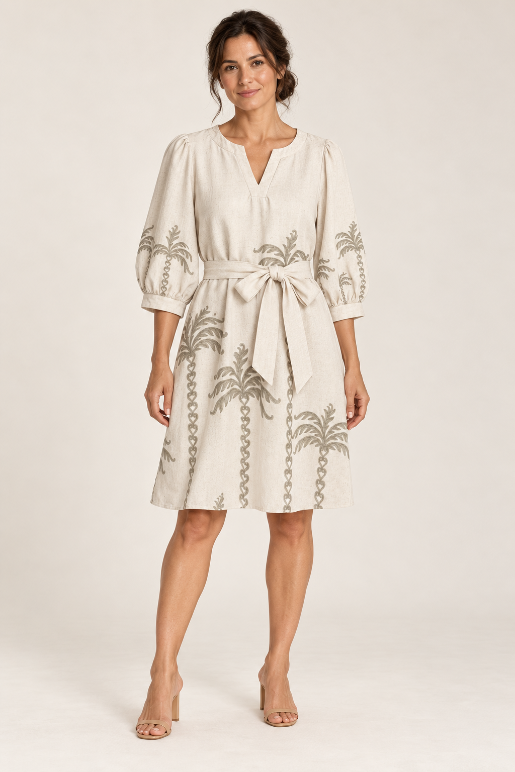 Model wearing the Smashed Lemon palm tree shift dress in off white with the belt tied at the front