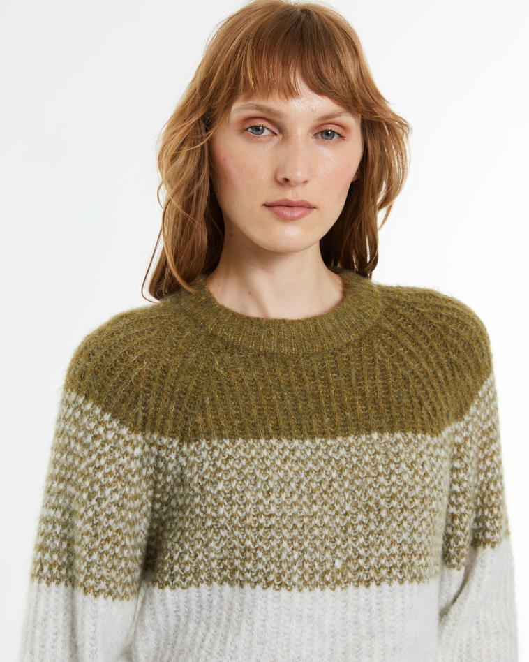 Close-up of the ribbed crew neckline and textured knit on the Andam colour block knit jumper in khaki and cream.