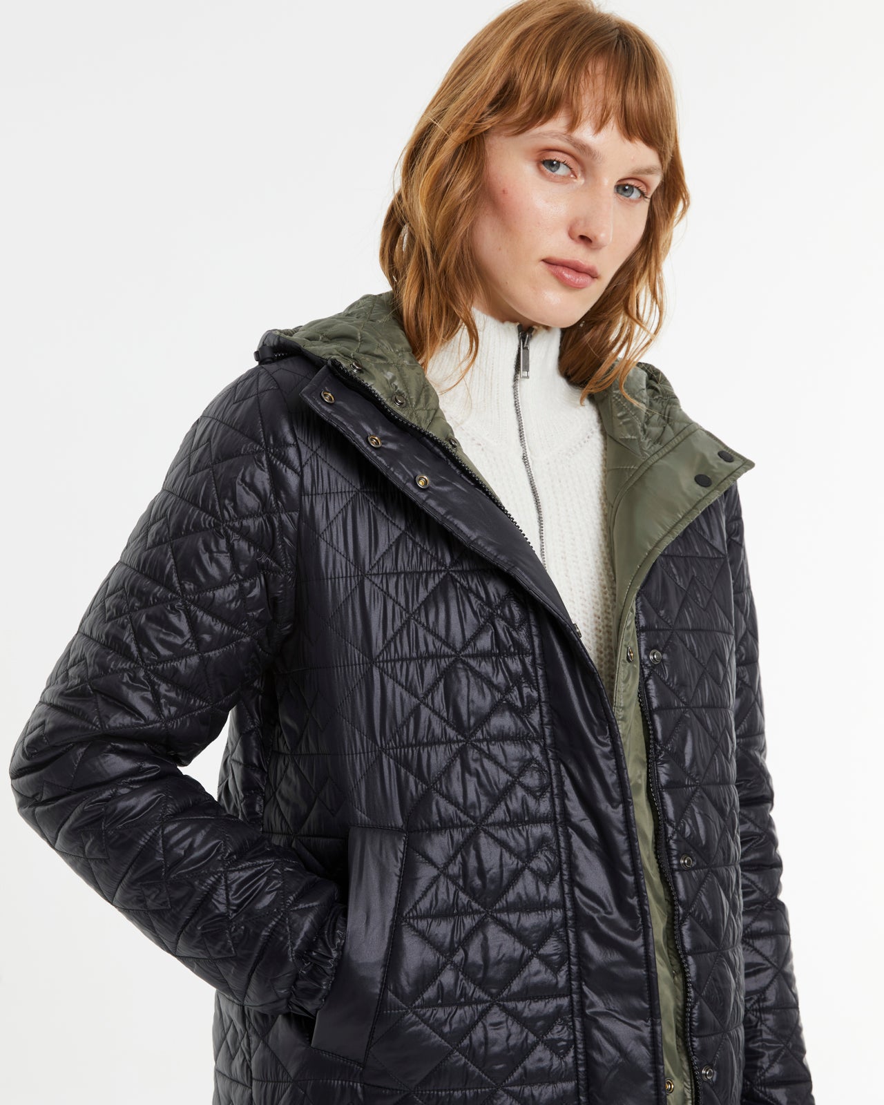 Reversible Andam quilted parka showing khaki exterior and black diamond-quilted interior with hooded design