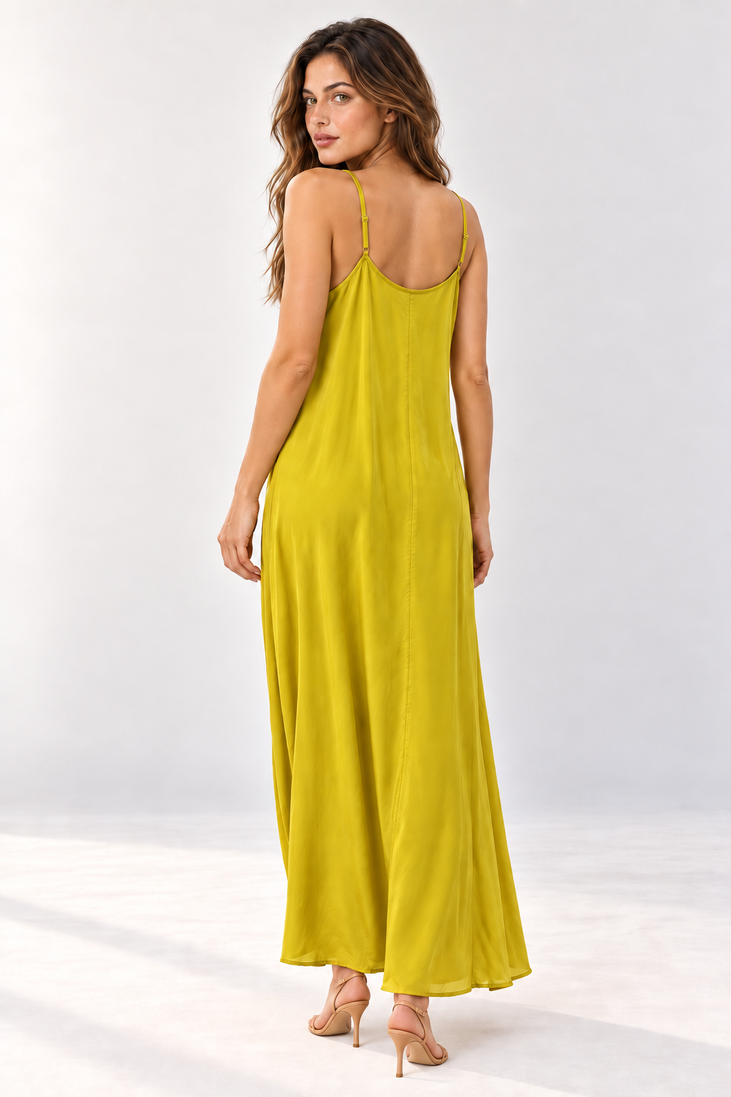 Back view of the Suzy D Suzie maxi slip dress on a model, showing the thin straps and scoop back.