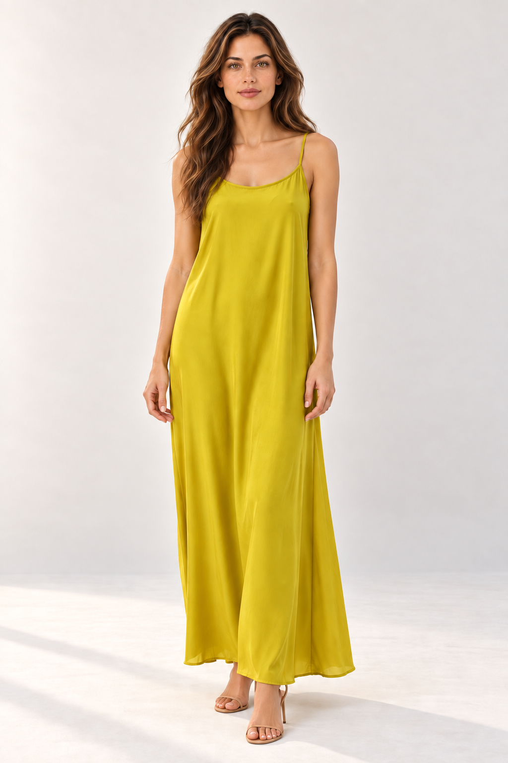 Model wearing the Suzy D Suzie shoestring strap maxi dress in Vibrant Amber Haze, front view.