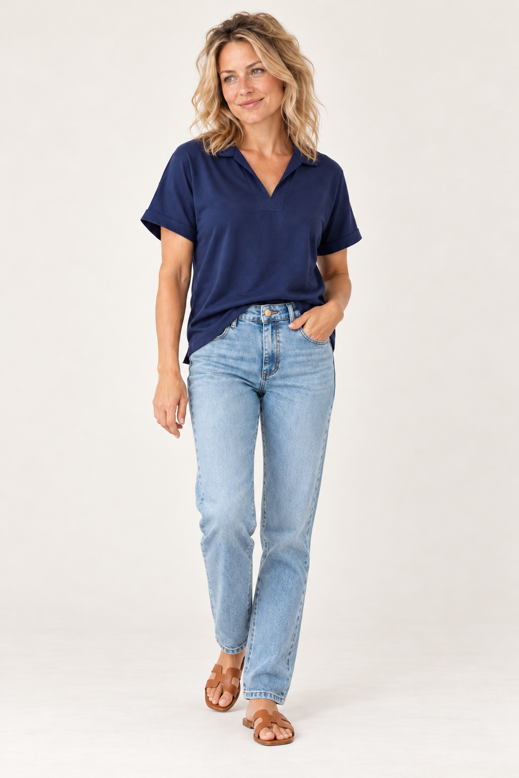 Gordon Smith Fairway Polo Top in Navy worn walking, with La Petite Étoile Brieg jeans in Light Stone