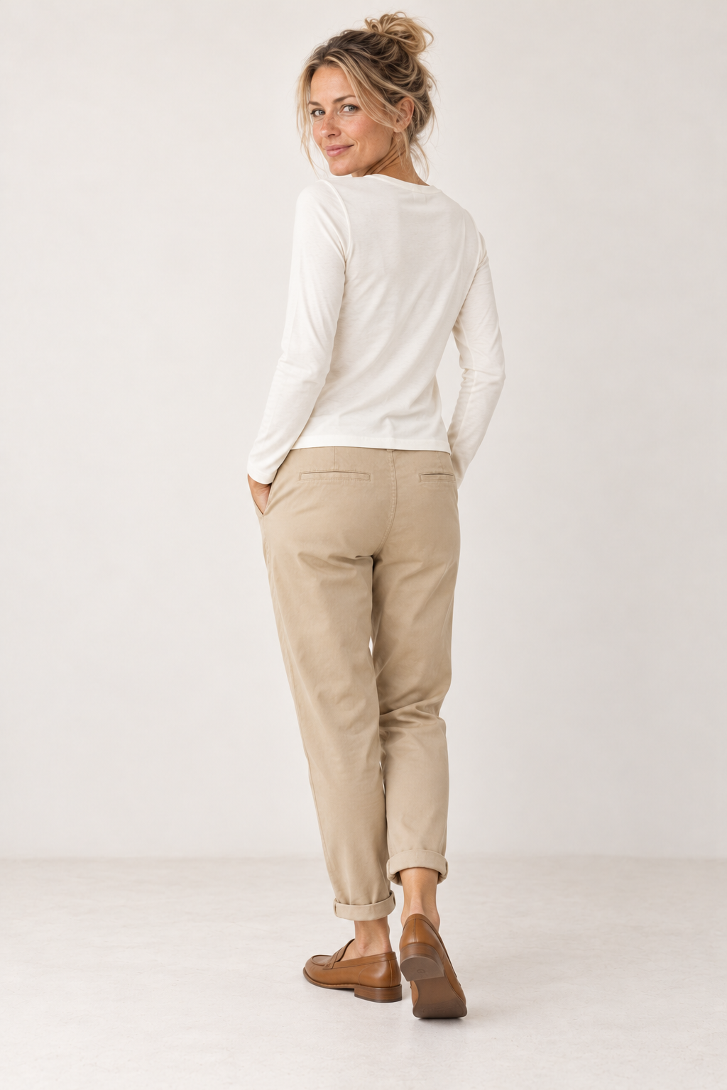 Back of the YAYA off white long sleeve T-shirt on the model, worn with sand beige trousers