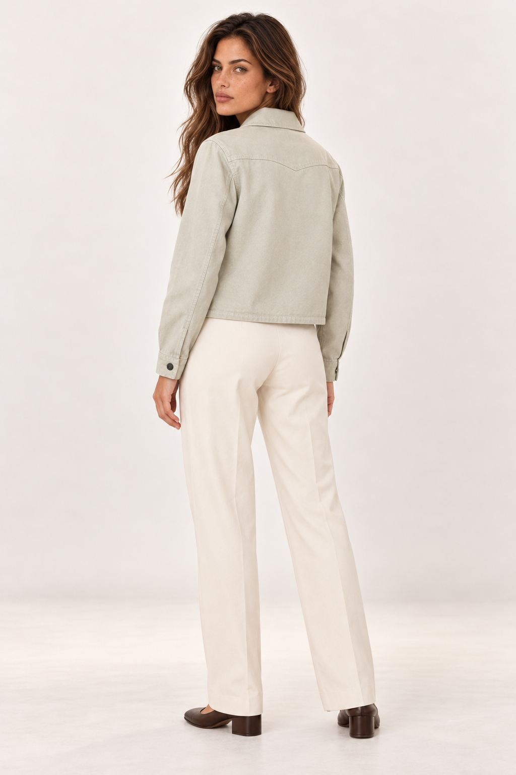 Back of the YAYA Sandstone Beige denim jacket on the model, showing the yoke seam and cropped length