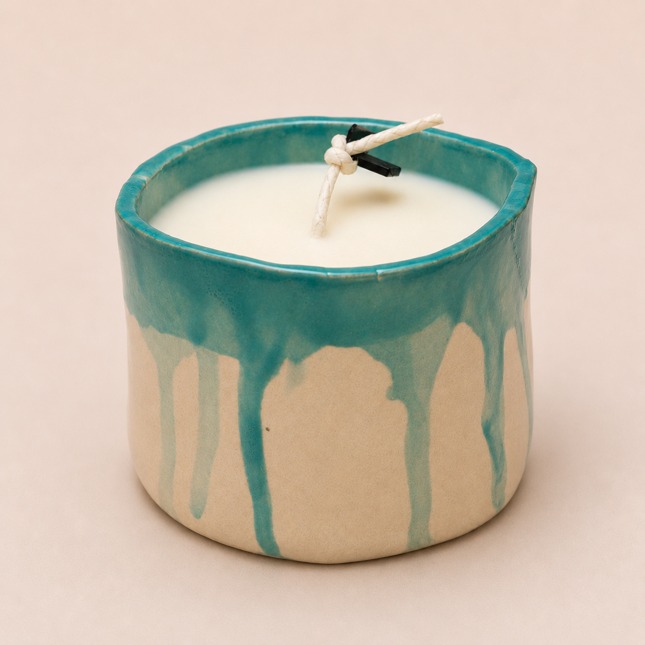 Fragile by Ilene Bergamot and Sandalwood large candle in a handcrafted ceramic vessel with turquoise drip glaze finish.