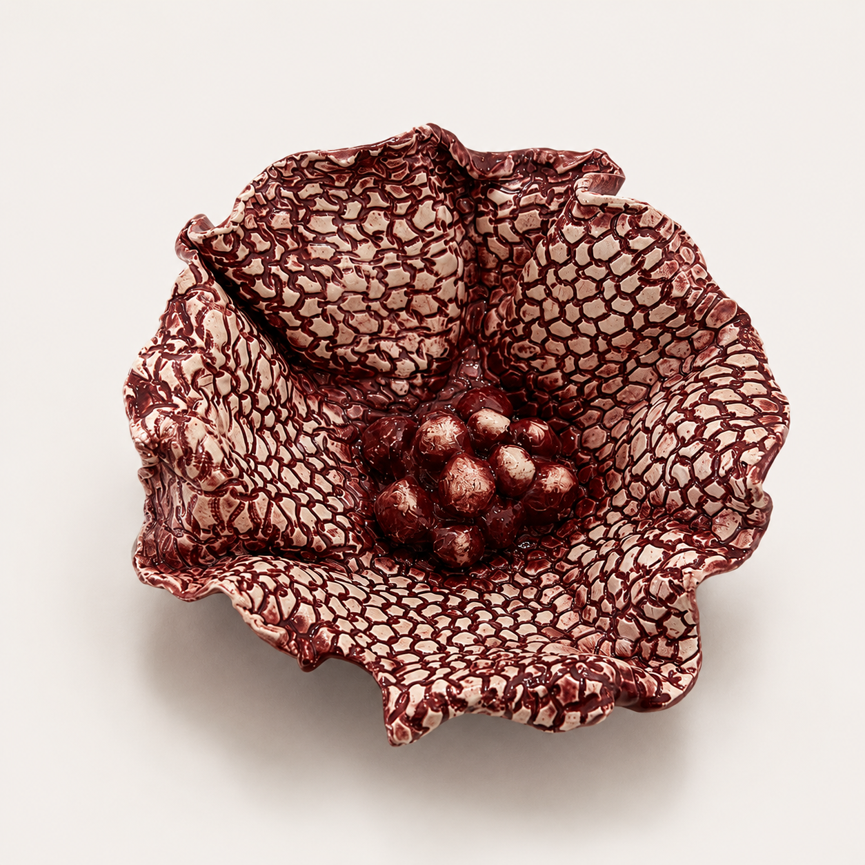 Handcrafted Floral Fragments ceramic wall art by Ilené Bothma featuring an organic floral-inspired sculptural form with intricate texture and a rich burgundy glazed finish.