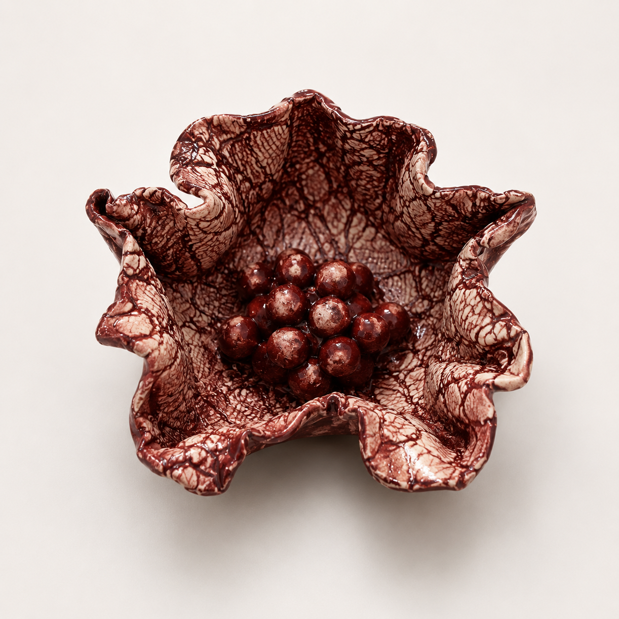 Handcrafted Floral Fragments ceramic wall art by Ilené Bothma featuring an organic floral-inspired sculptural form with intricate texture and a rich burgundy glazed finish.