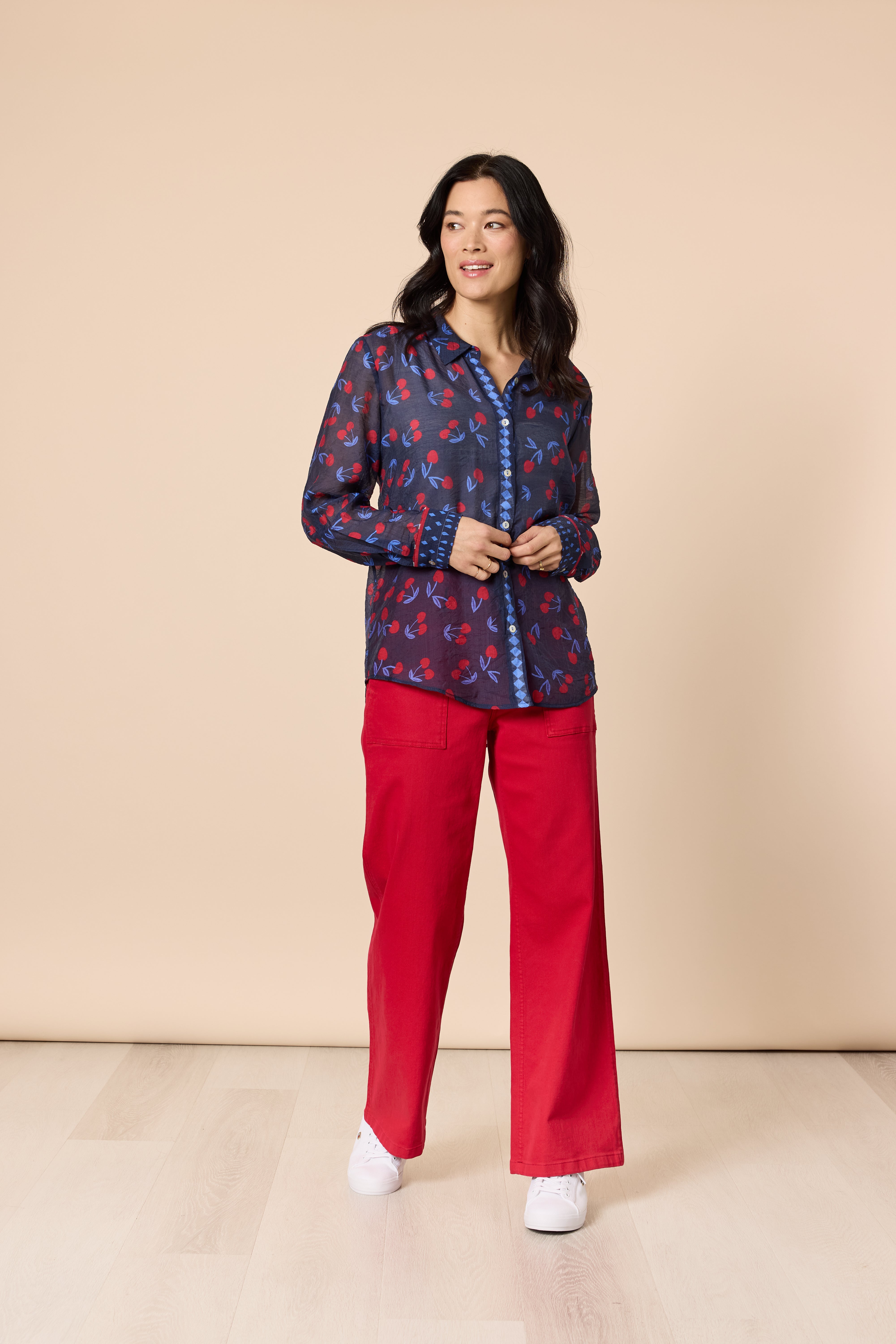 Model wearing Gordon Smith cherry delight shirt with red trousers