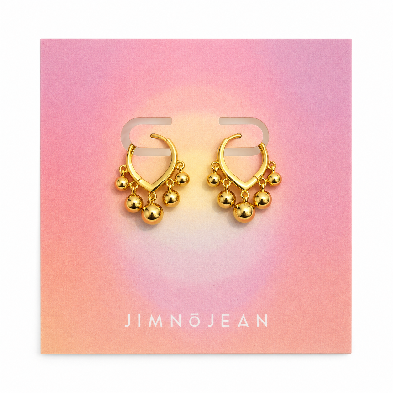 Jimnojean gold huggie earrings with dangling charm details