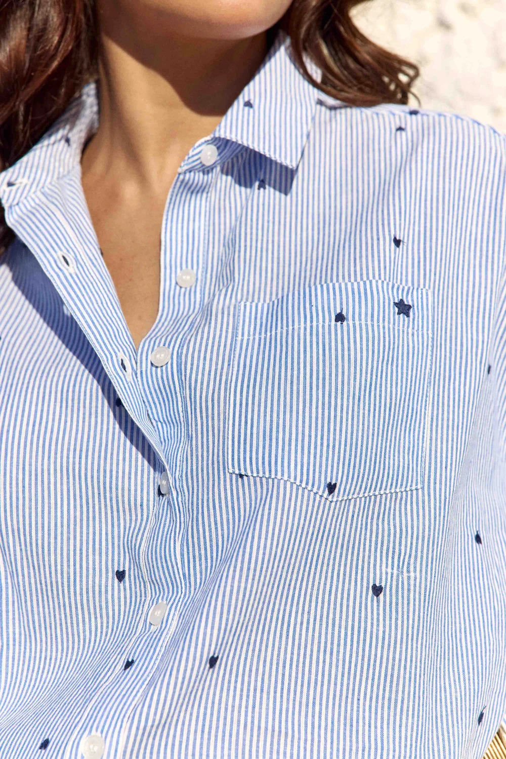 La Petite Étoile Coraline shirt showing blue pinstripes, embroidered hearts, chest pocket and button front