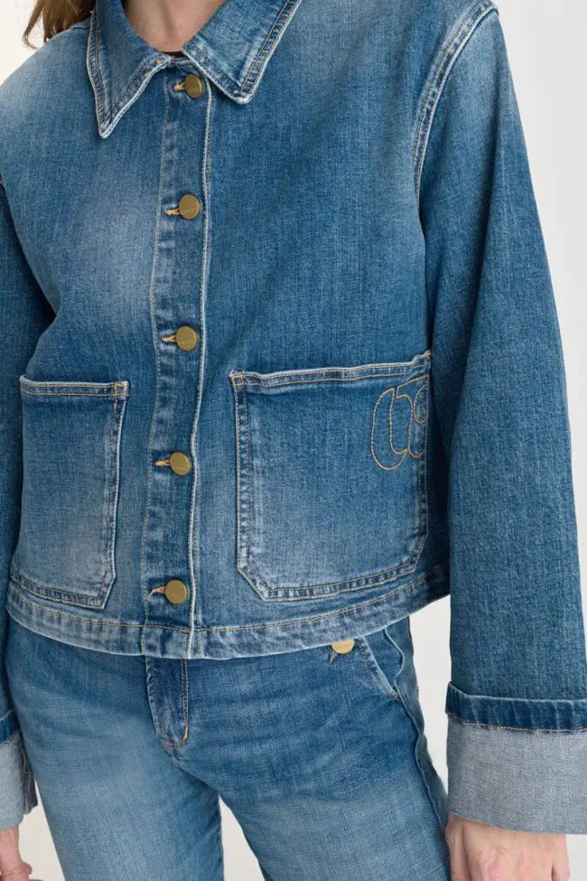 Close-up of the Le Temps des Cerises Aleska denim jacket showing oversized patch pockets and button closure.