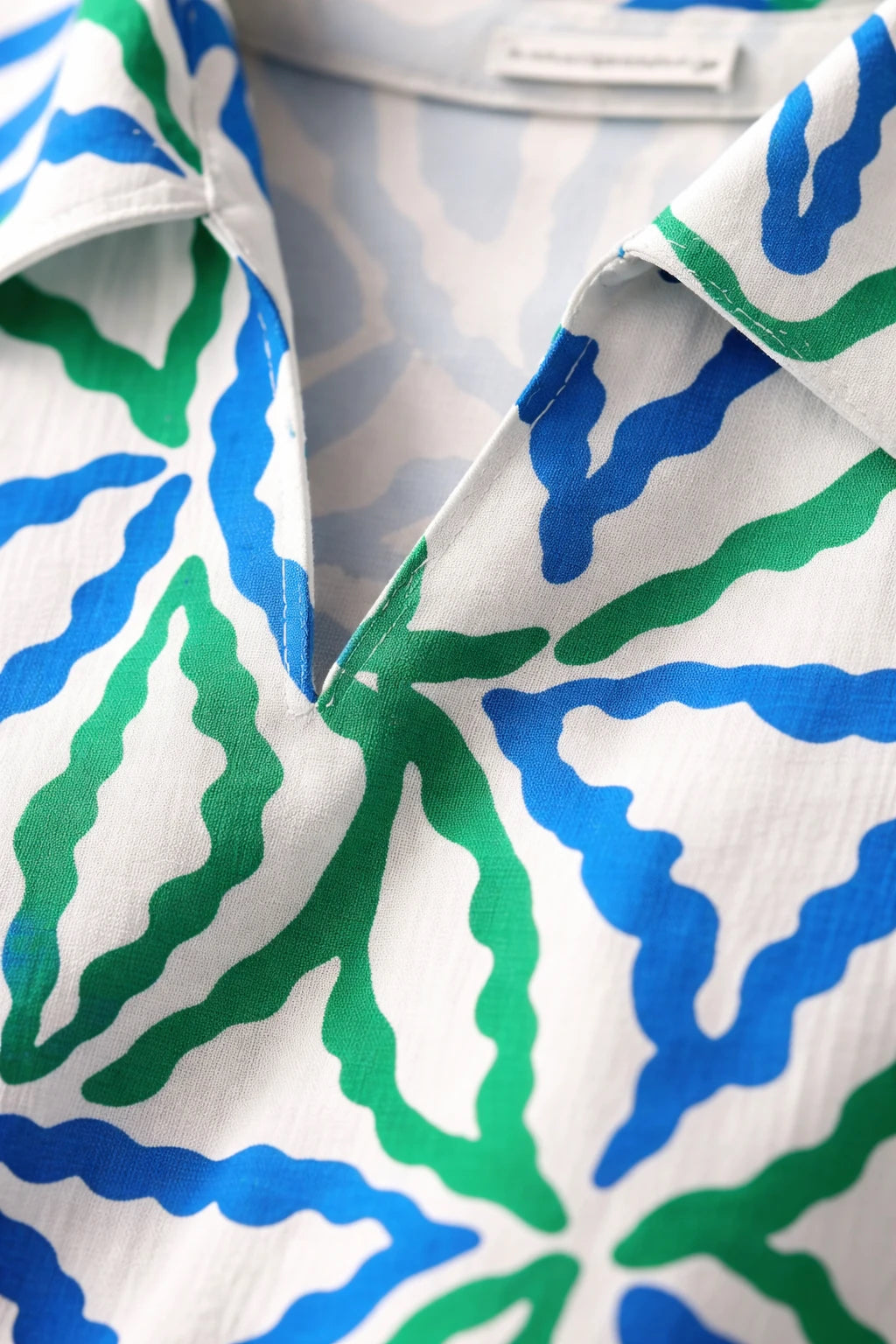 Detail of Smashed Lemon dress cobalt blue green fabric and neckline