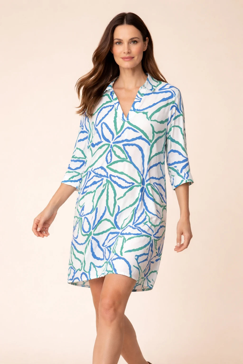 Model wearing Smashed Lemon cobalt blue green printed dress crossed legs