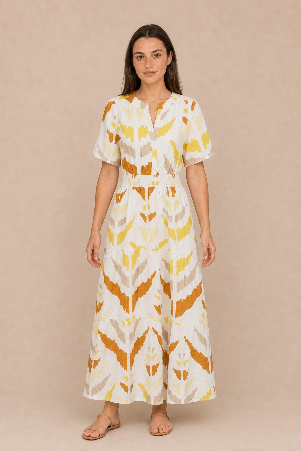 Smashed Lemon white and yellow printed maxi dress on model, featuring a button front, shirred waist and flowing tiered skirt.