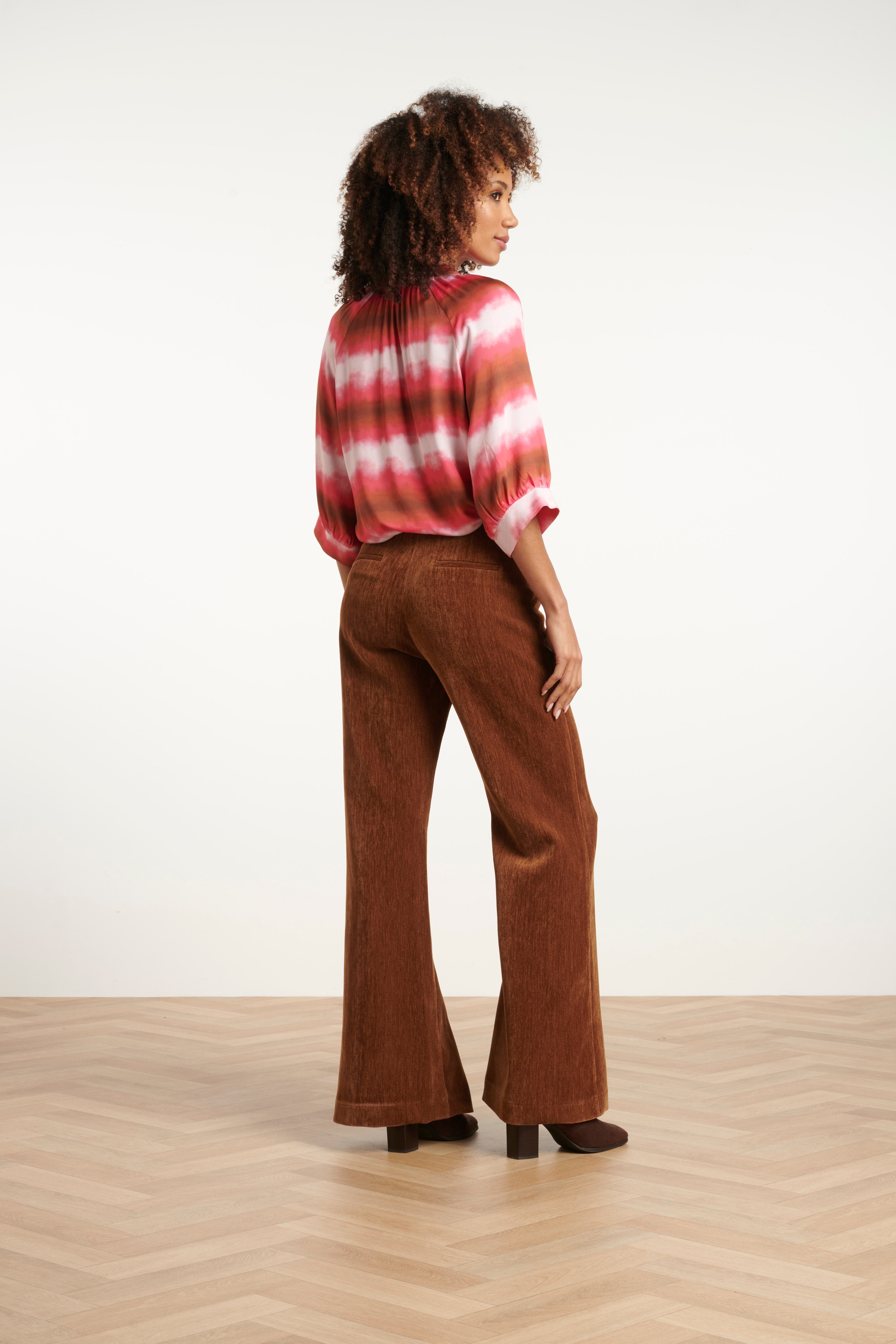 Smashed Lemon flared velvet pants in rich brown, high-waisted with wide flared leg, side view