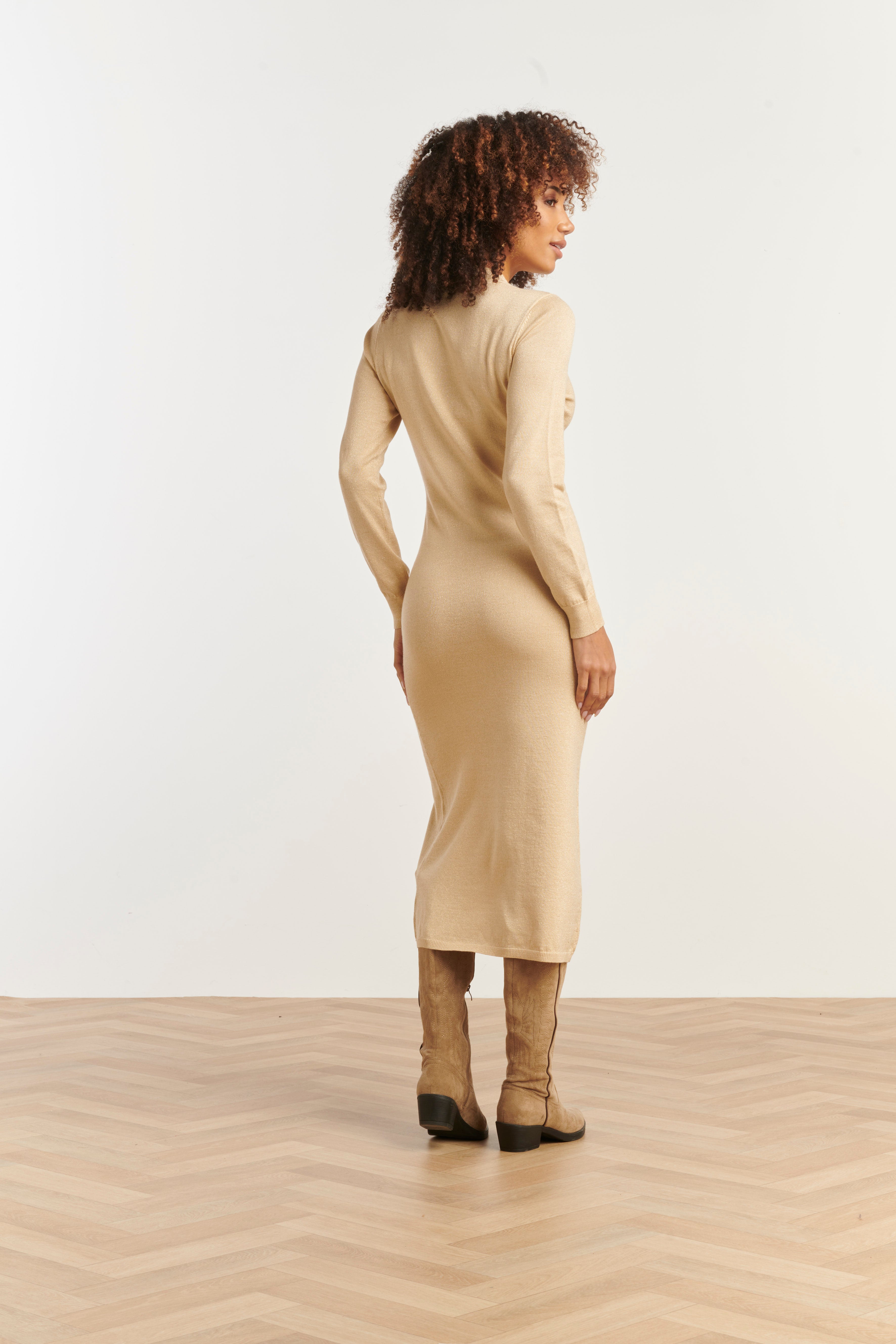 Smashed Lemon knit dress in sand with gold lurex shimmer, fitted midi silhouette, long sleeves and high neckline, side view