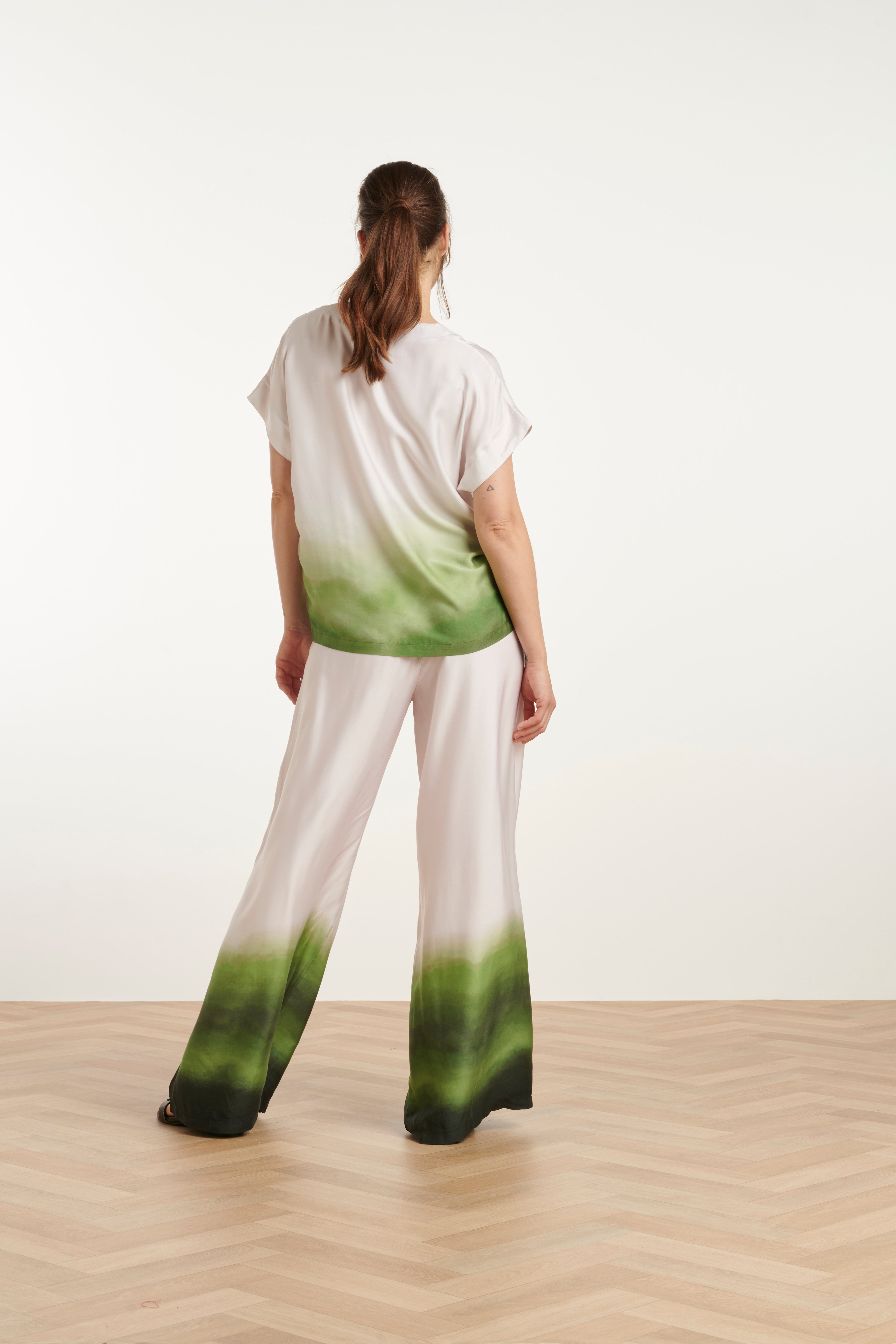 Model wearing Smashed Lemon ombre satin trousers with matching ombre top