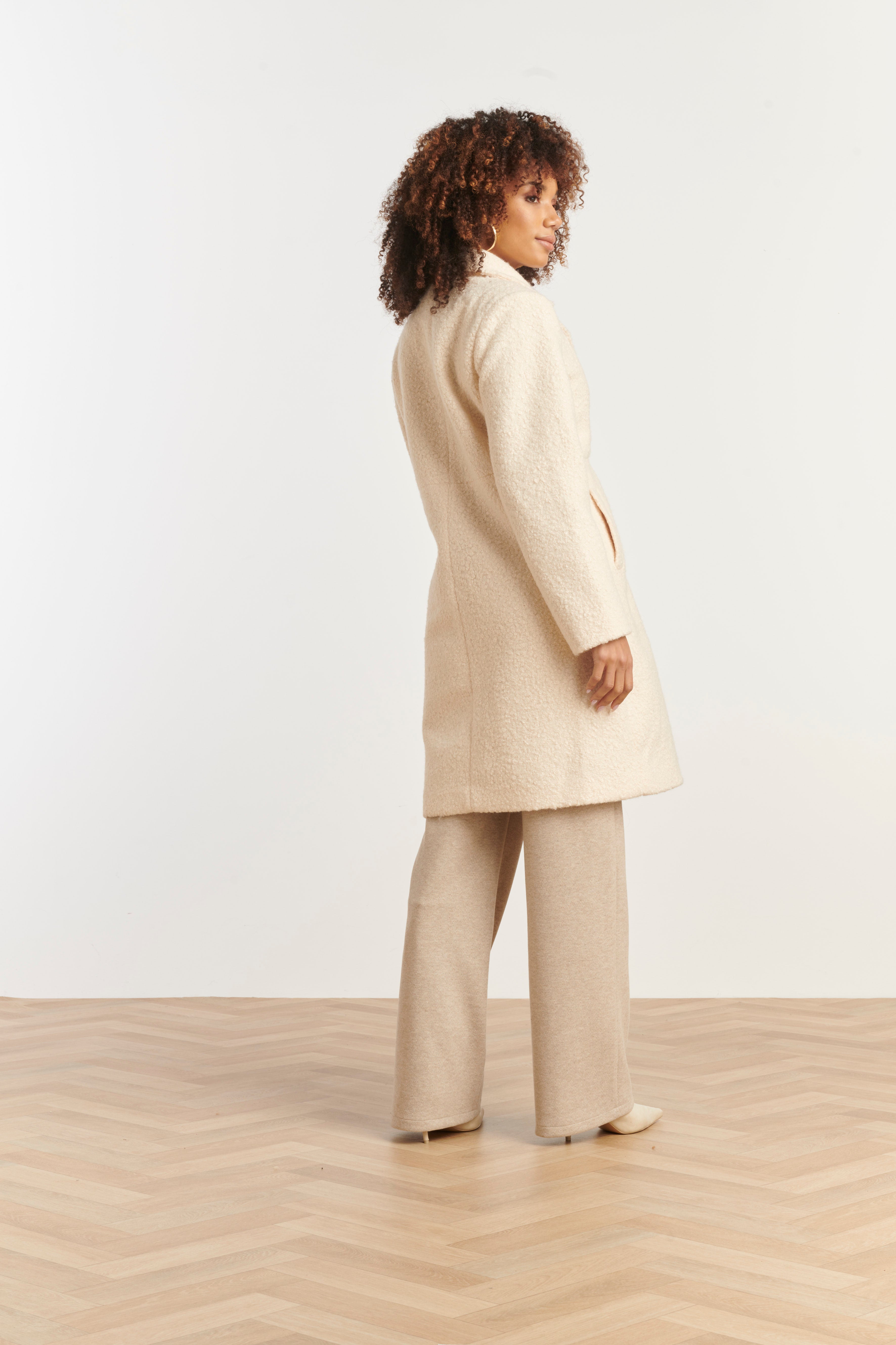 Smashed Lemon textured coat in off-white boucle, knee-length with notched lapels and button front, side view