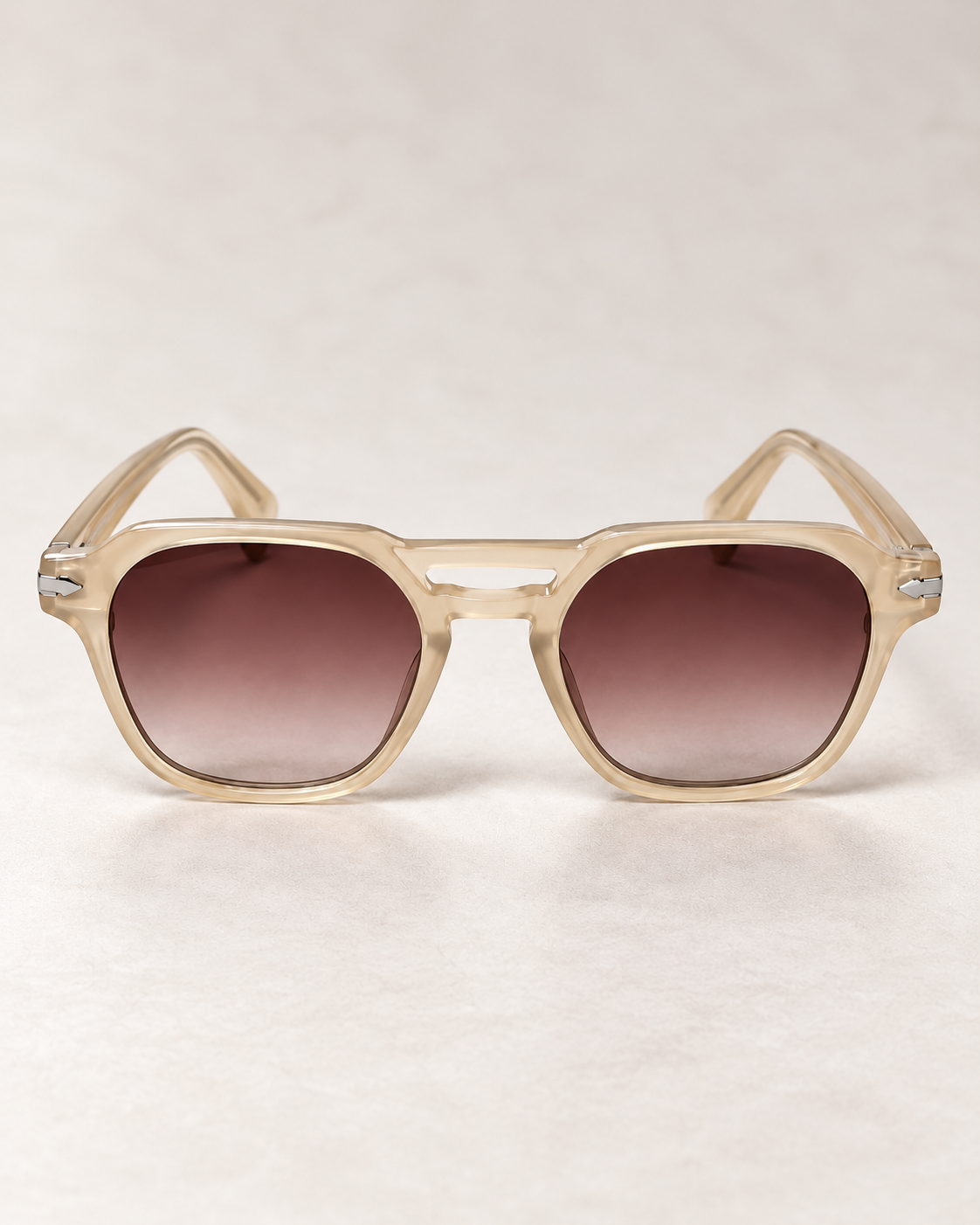Front view of YAYA Sofia Sunglasses in Kit Beige, featuring translucent champagne-beige frames, brown gradient lenses and decorative bridge detailing