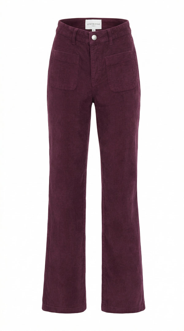A pair of La Petite Etoile corduroy pants in a deep burgundy shade, featuring a high-rise fit, front patch pockets, and a soft velour textured finish.