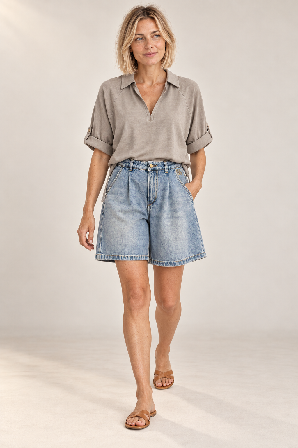 Model walking in the Lova Short in Blue, showing the wide leg in movement