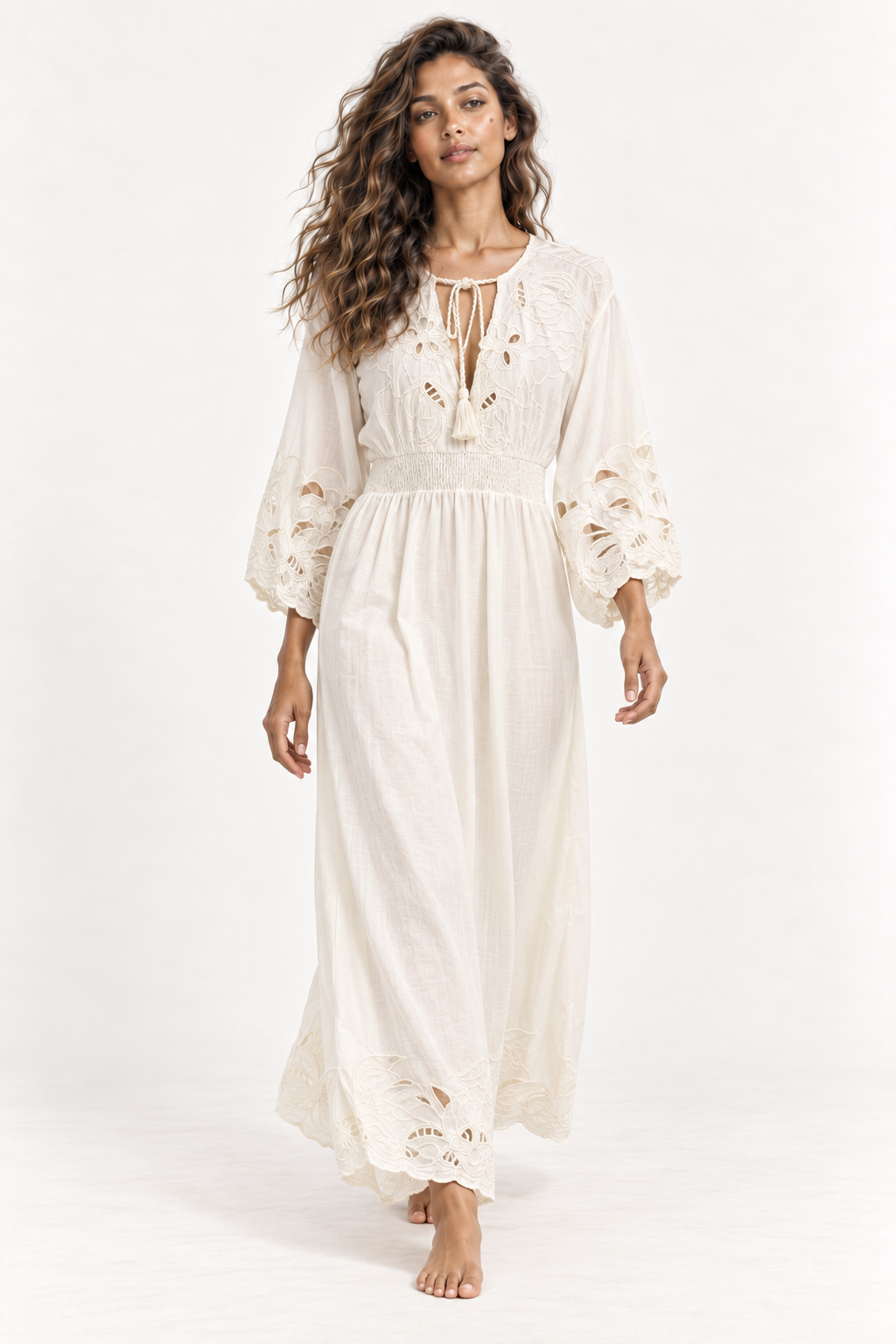 Model walking in the Piti Cuiti cutwork maxi dress, showing the blouson sleeves and full gathered skirt
