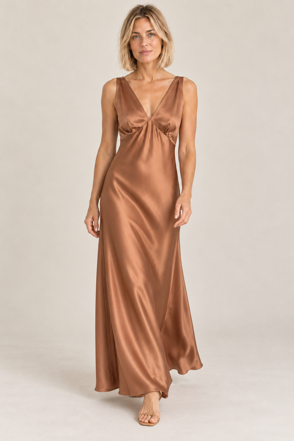 Model walking in the La Petite Étoile Rosily satin midi dress in camel