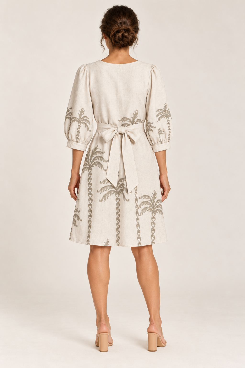 Back view of the Smashed Lemon off white palm tree dress with the belt tied in a bow