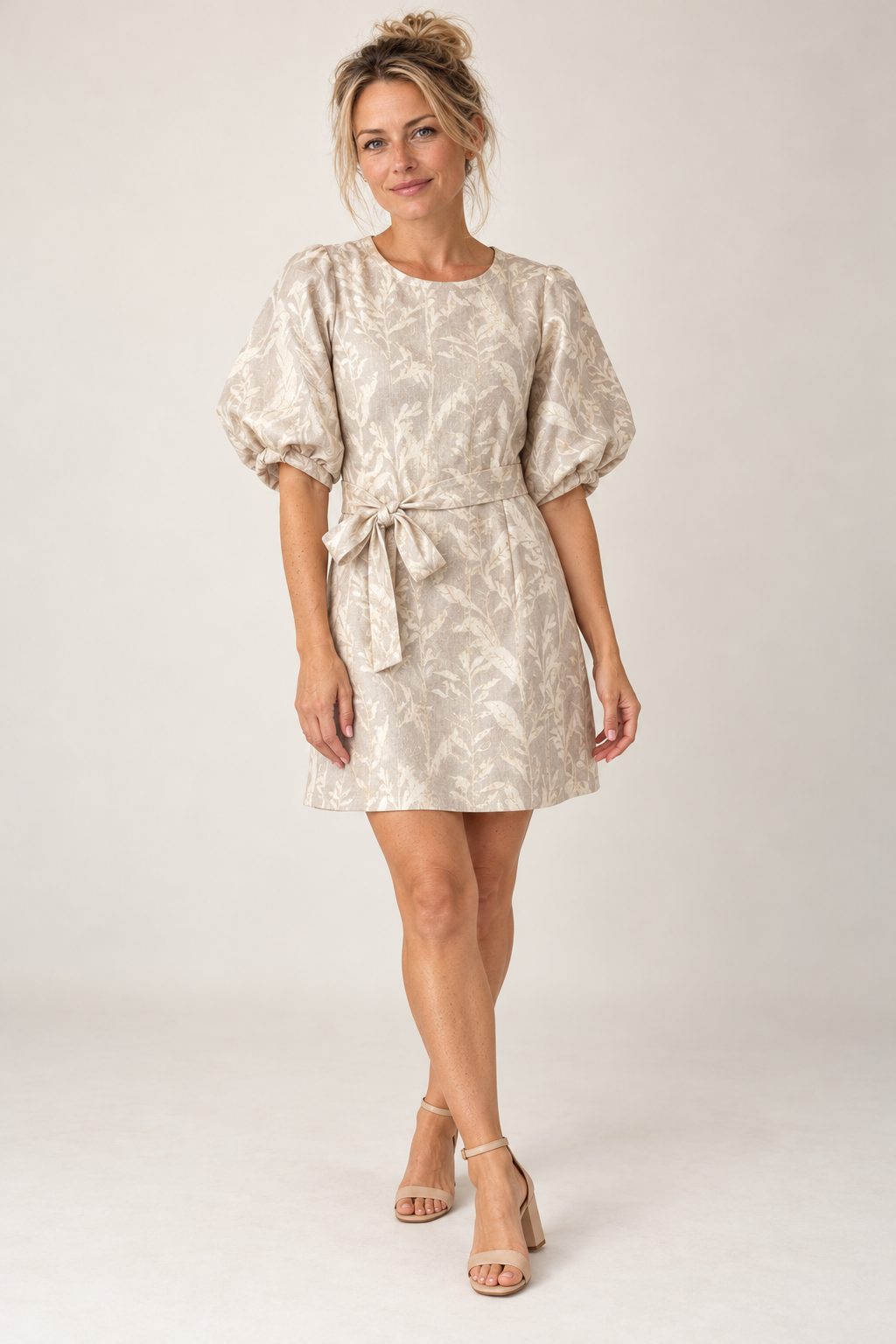 Model wearing the Smashed Lemon puff sleeve dress in dark sand and gold, front