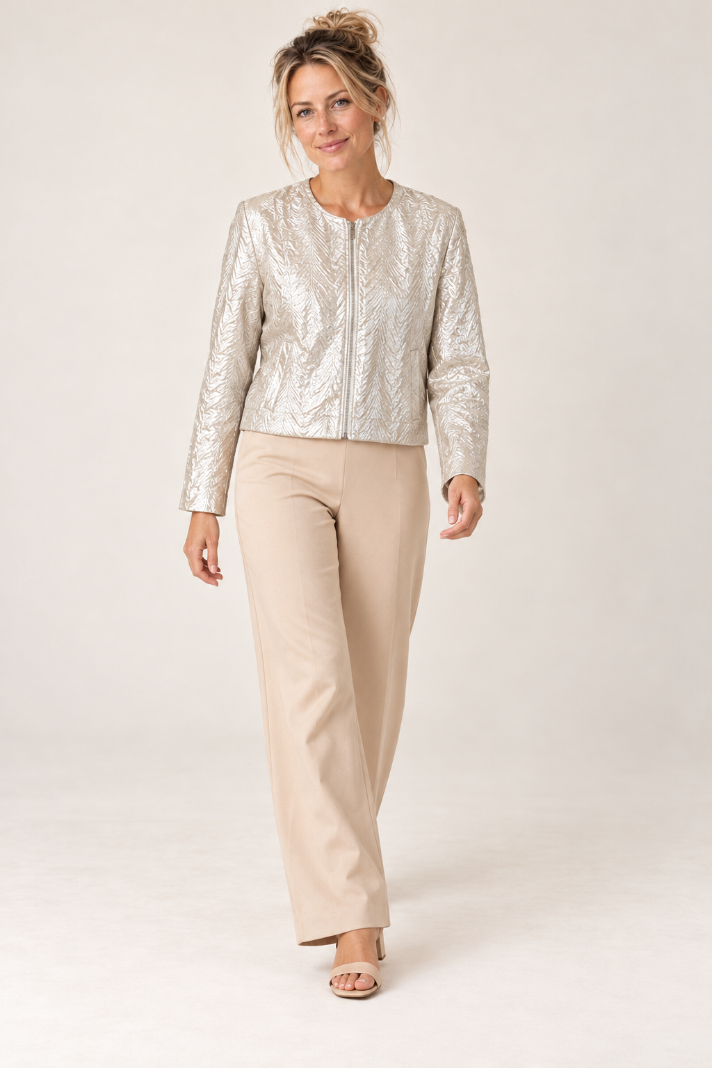 Model walking in the Smashed Lemon silver metallic jacket and sand wide leg pants