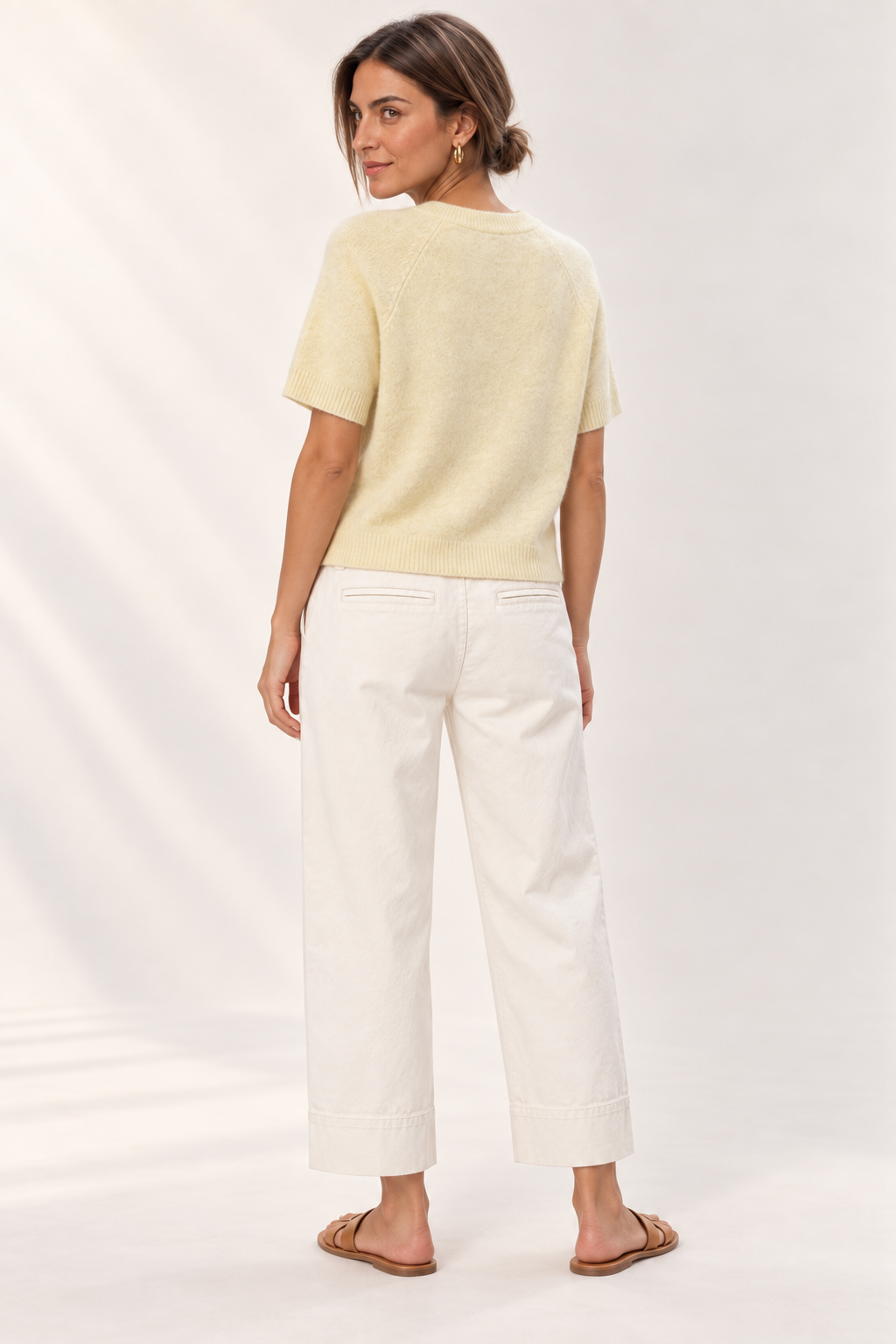 Back view of the YAYA Raglan Short Sleeve Knit in Reed Yellow Melange, model with hair up