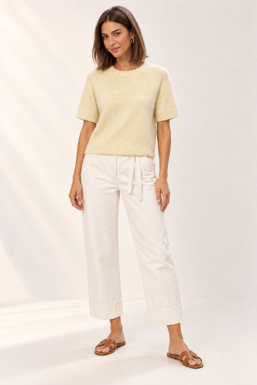 Model wearing the YAYA Raglan Short Sleeve Knit in Reed Yellow Melange with off-white denim, front view