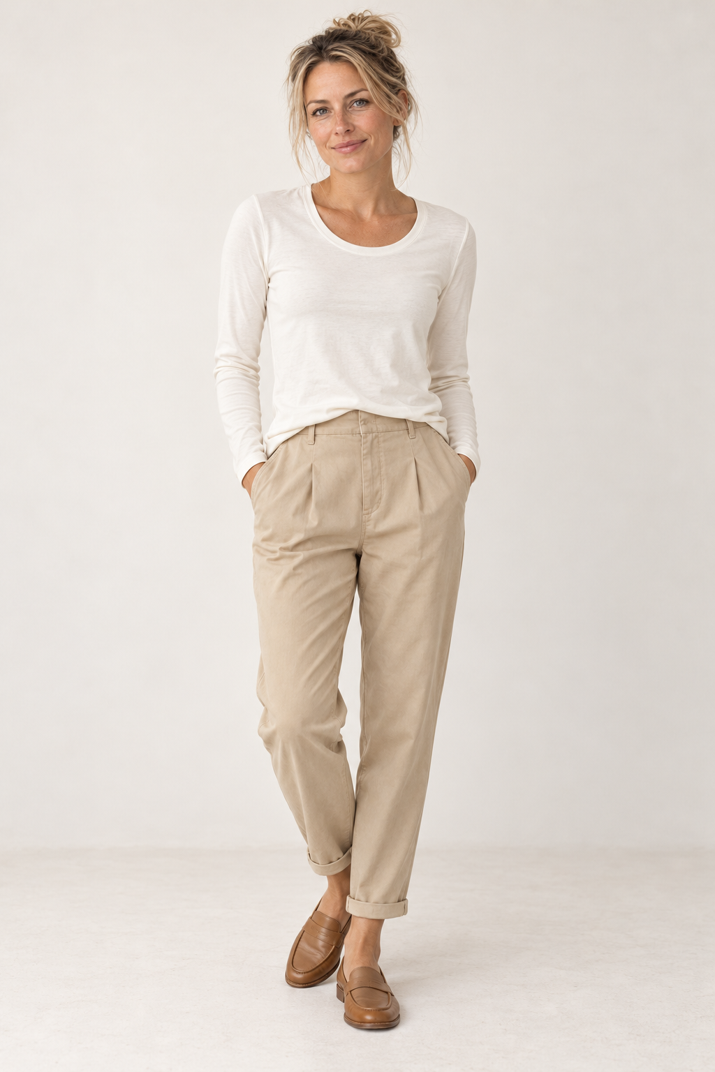 Model wearing the YAYA Round Neck Long Sleeve T-Shirt in Off White with YAYA Woven Loose Fit Trousers in Sand Beige, full length front