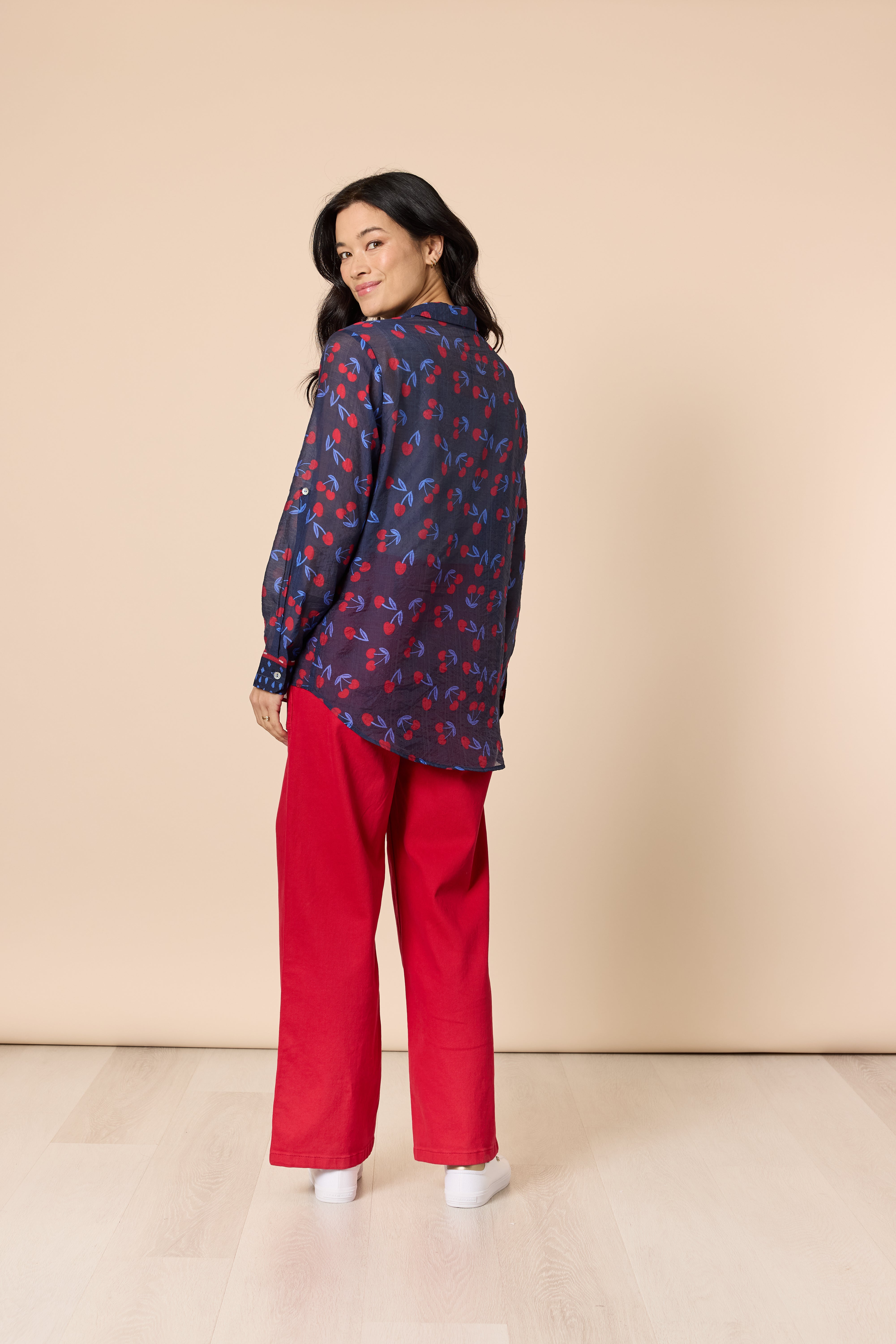 Back view of navy shirt with red cherry print
