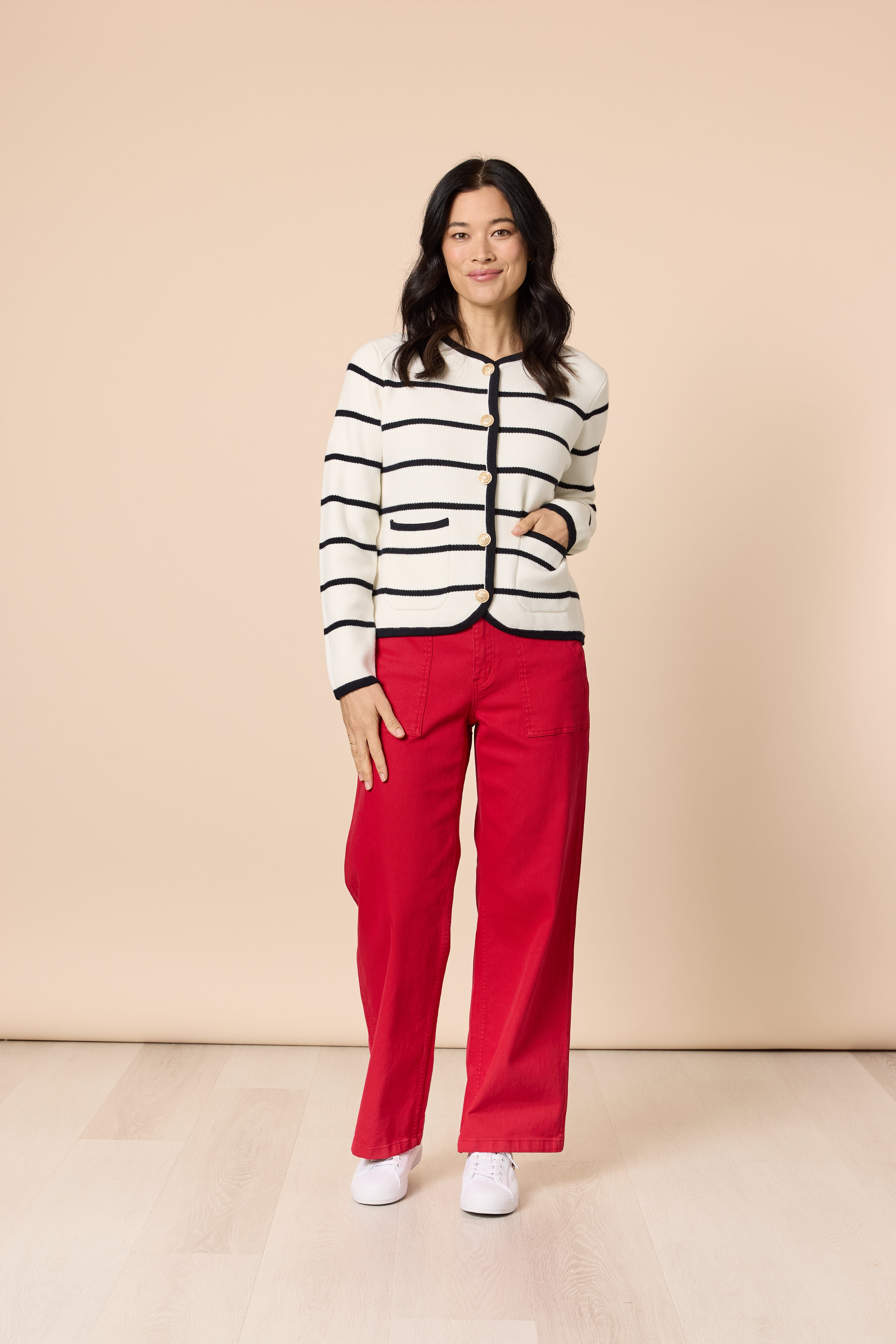 Model wearing Gordon Smith Hampton cardigan with red trousers front view