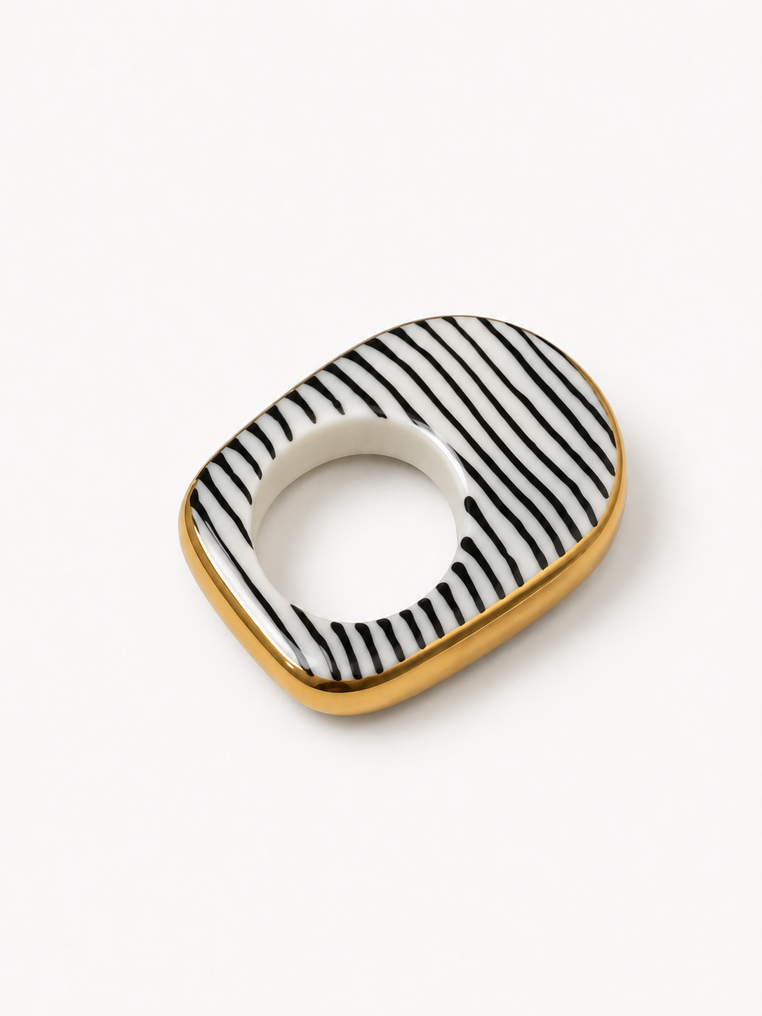JVR porcelain ring featuring a black and white striped design with a luxurious gold rim.