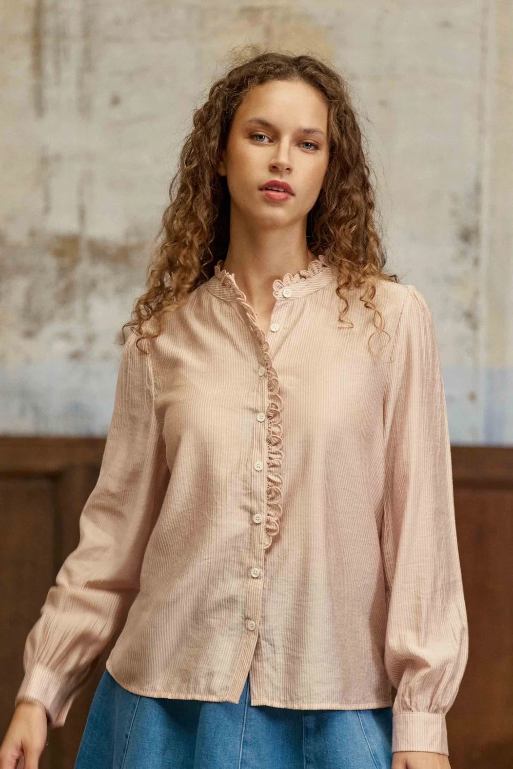 La Petit Étoile Boya blouse in powder front view with ruffled trim and button front