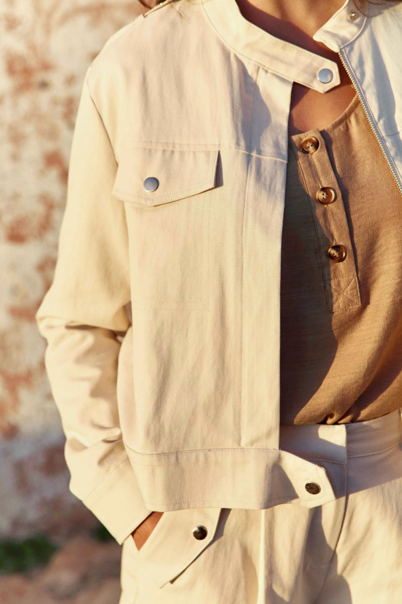 Close-up of the flap chest pocket and zip front on the La Petit Étoile Nevada Jacket in Natural