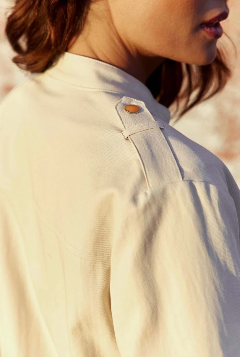 Close-up of the snap-button shoulder epaulet on the La Petit Étoile Nevada Jacket in Natural