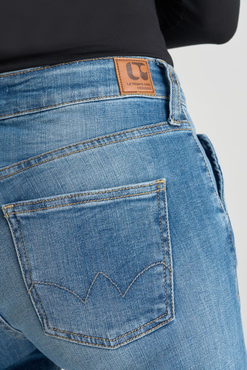 Close-up of back pocket stitching and logo patch on Le Temps des Cerises blue jeans