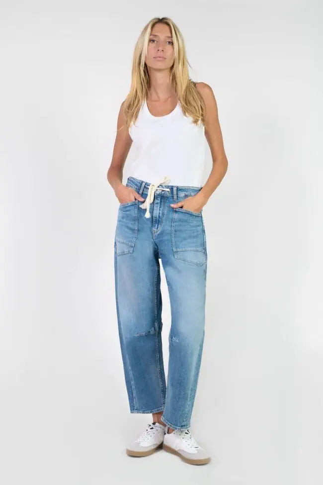 Model wearing Le Temps des Cerises Madie Denim Jeans in Blue showcasing the relaxed barrel-leg silhouette and high-rise waist.