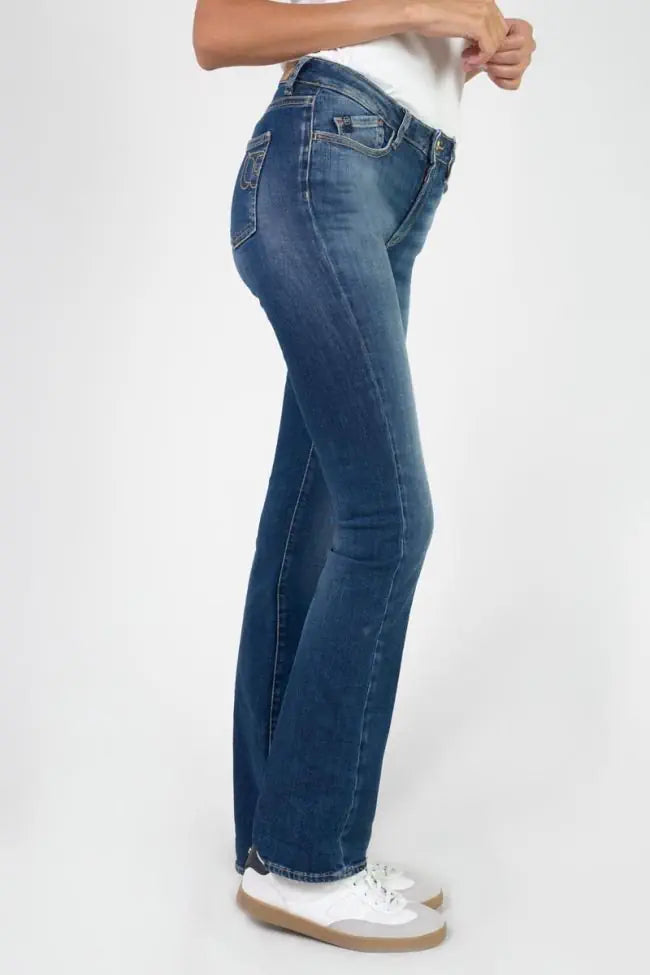 Side profile of Le Temps des Cerises Power Denim Jeans in Blue highlighting the slim fit through the thigh and bootcut leg.