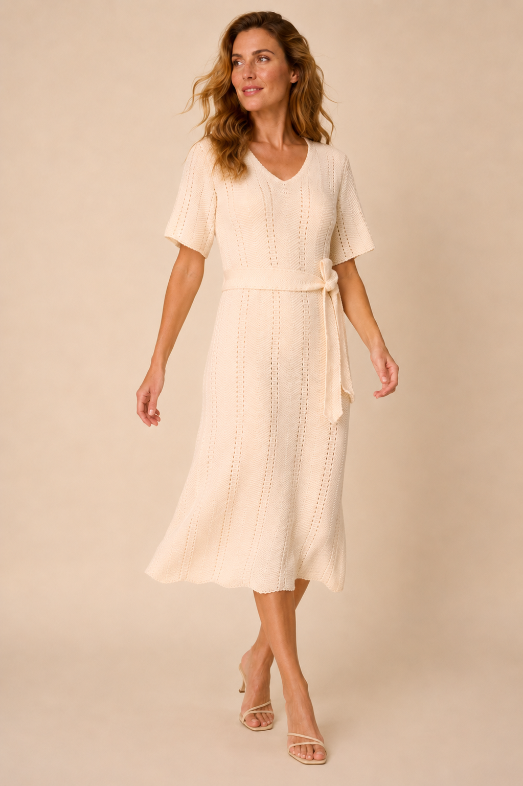 Smashed Lemon knit dress in off white worn by a model, in motion showing the soft drape — Boetiek, Cape Town