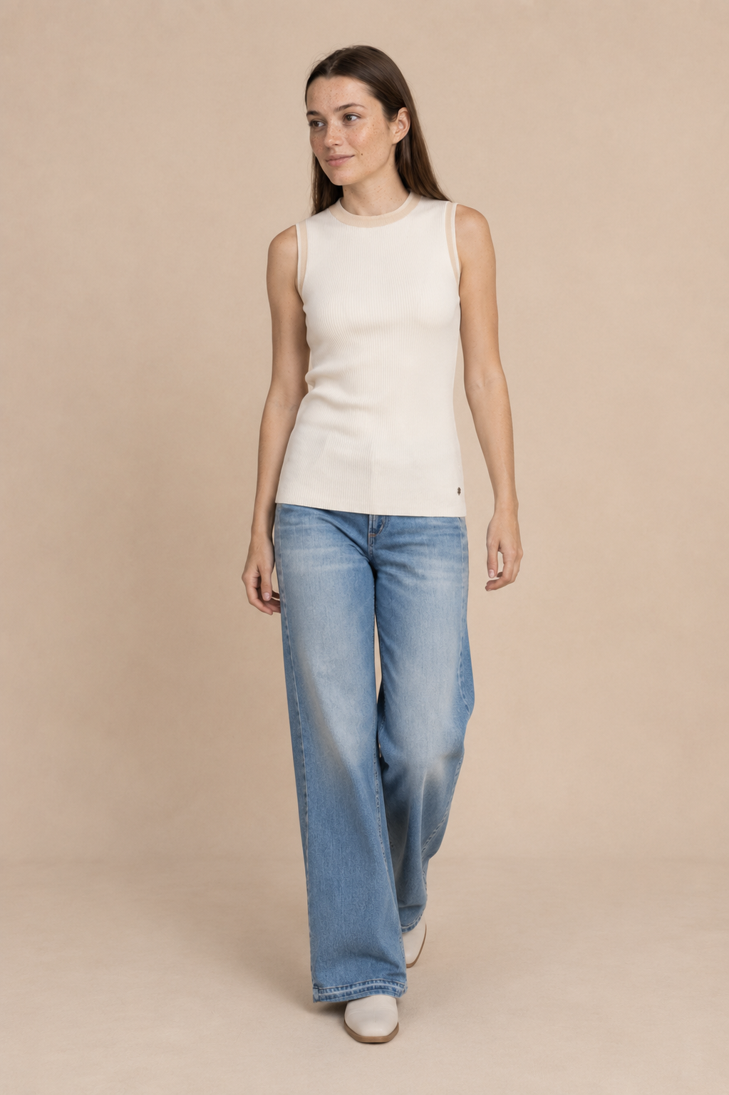 Smashed Lemon knit sleeveless top in off white and dark sand worn by a model, in motion — Boetiek, Cape Town