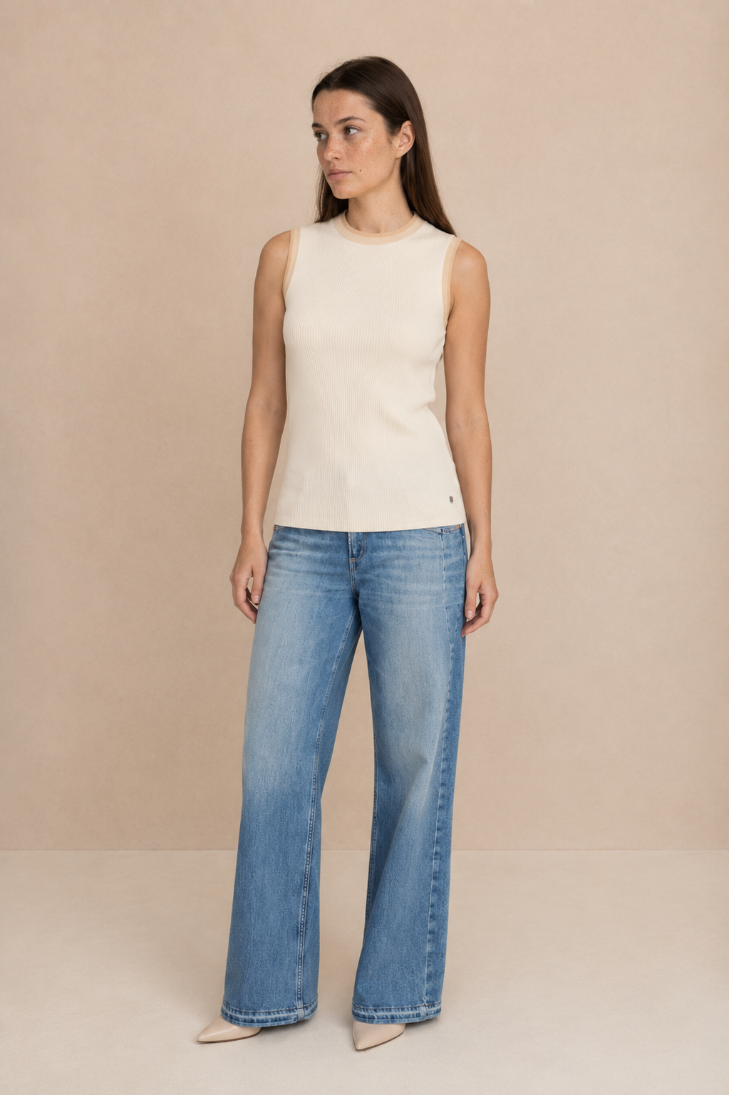 Smashed Lemon knit sleeveless top in off white and dark sand worn by a model, standing — Boetiek, Cape Town