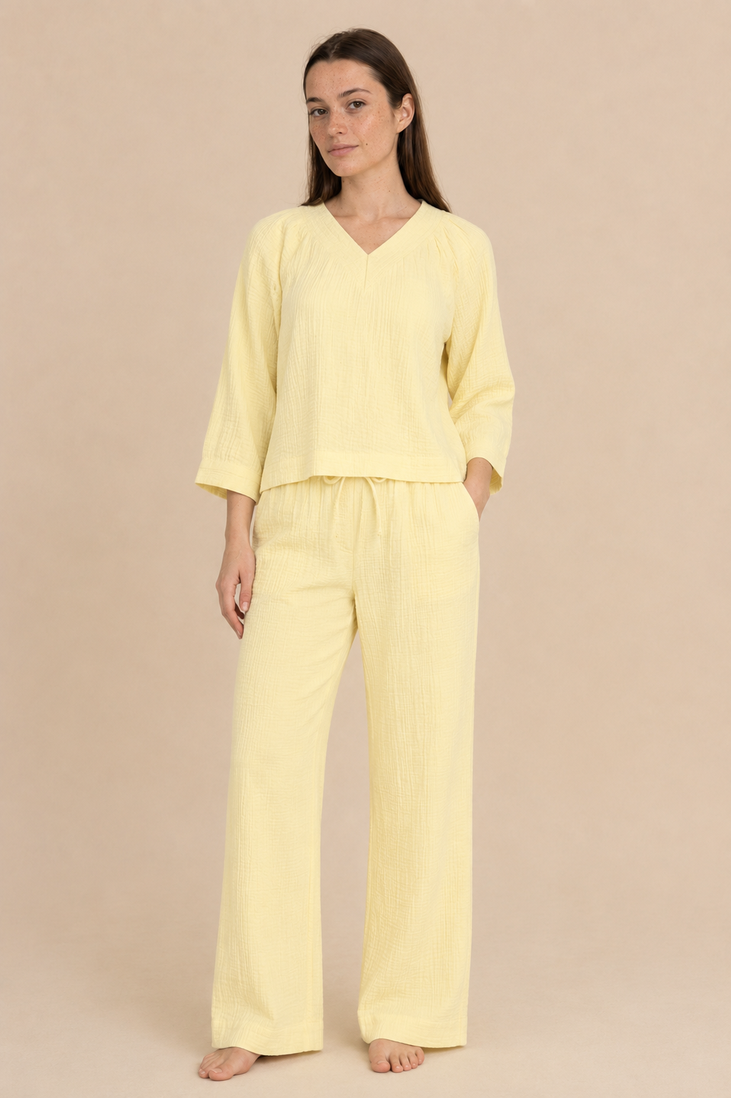 Smashed Lemon light yellow wide leg pants with relaxed fit and textured fabric, styled on model.