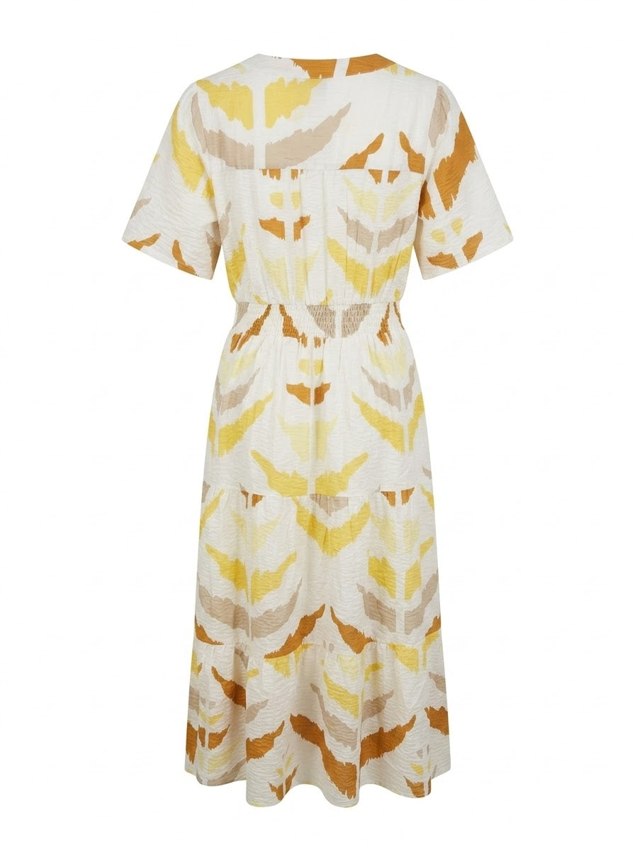 Smashed Lemon printed maxi dress in white and yellow with short sleeves, shirred waist and tiered skirt, back view.