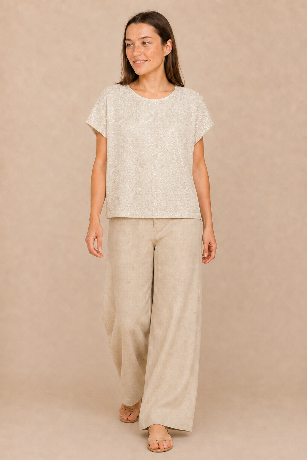 Smashed Lemon sand sequin top with short sleeves styled with relaxed wide-leg trousers
