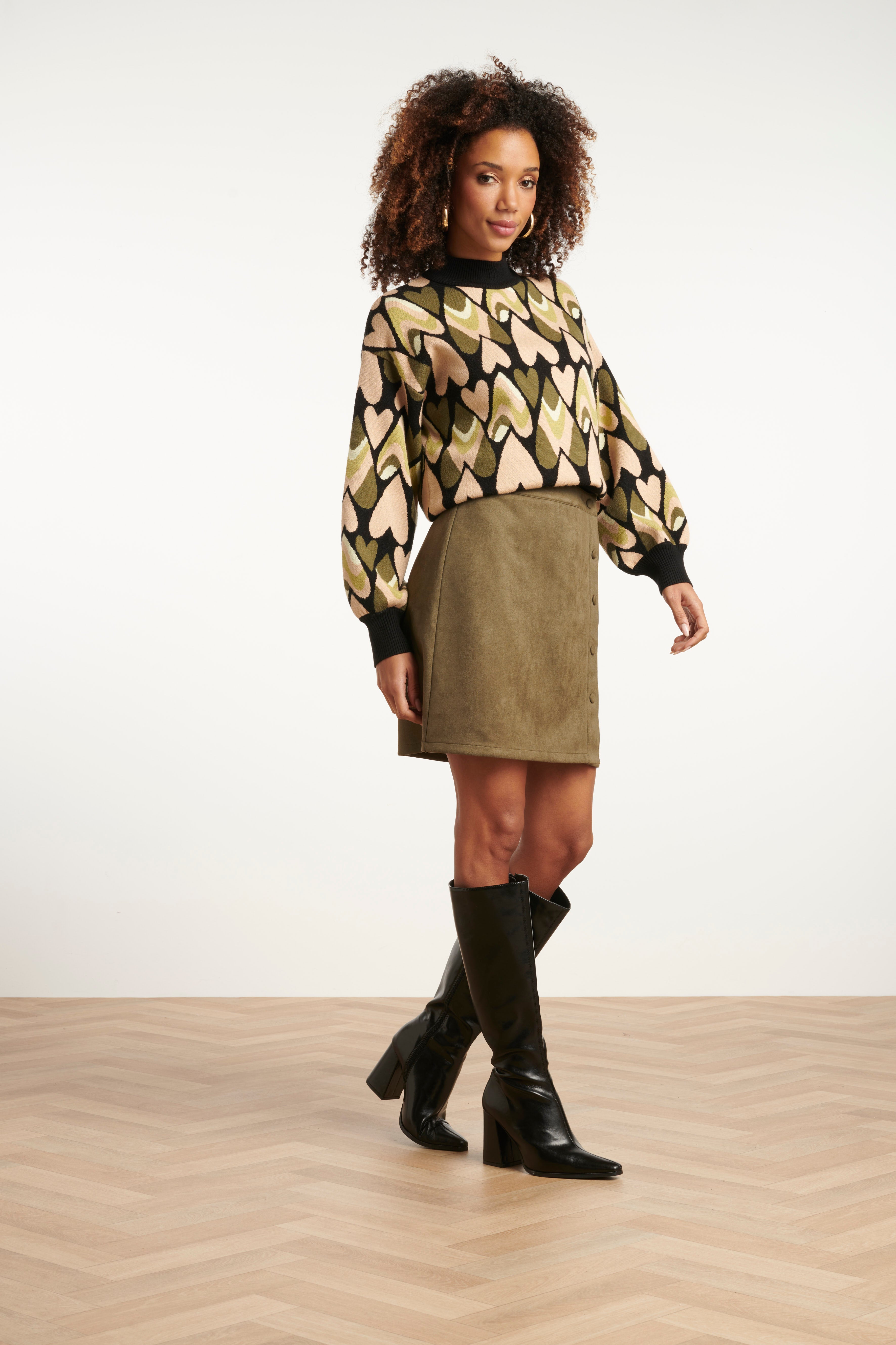 Smashed Lemon turtleneck knit top in black and army green abstract diamond print, long sleeves, three-quarter angle view