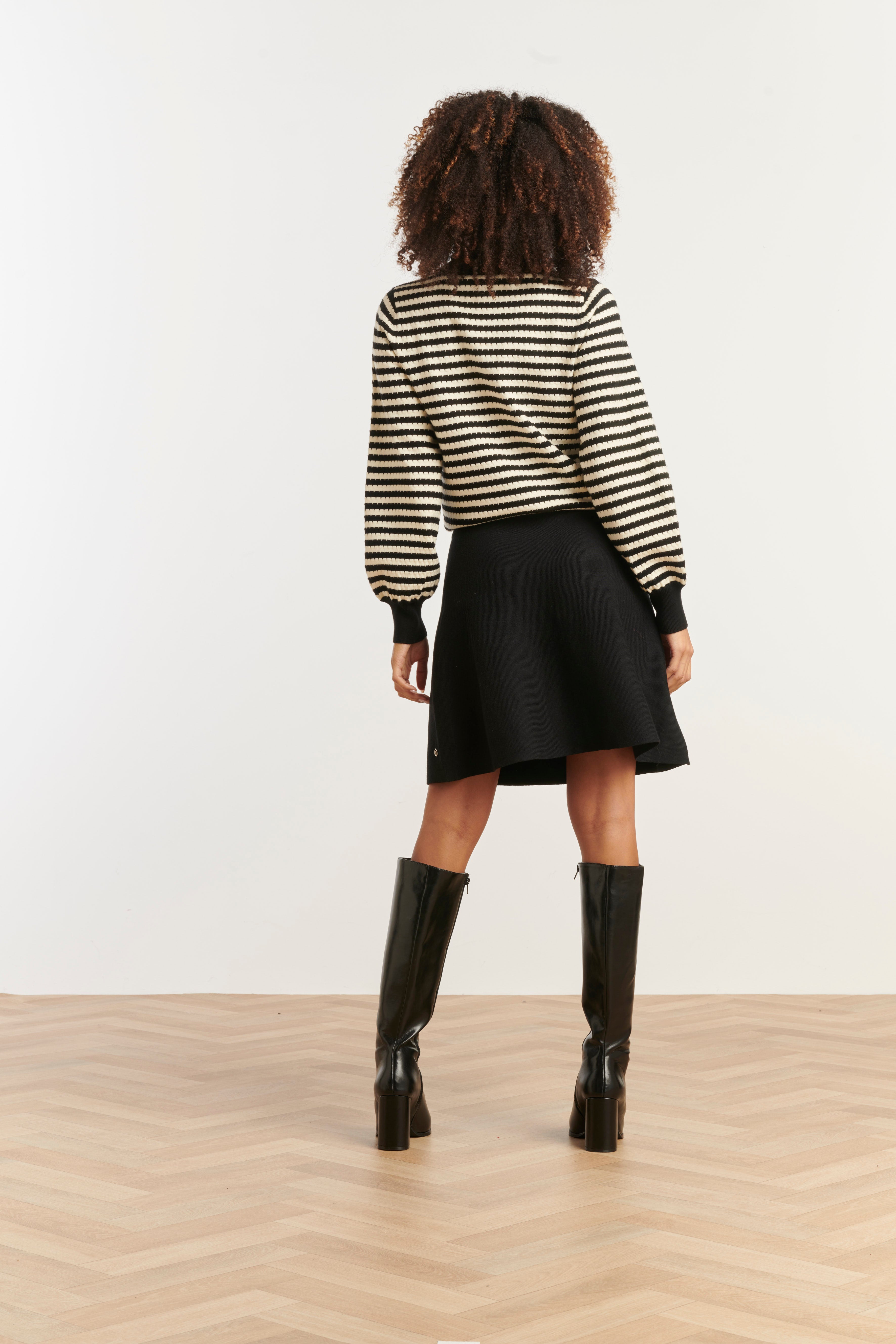 Smashed Lemon turtleneck knit top in black and off-white stripe, cropped fitted silhouette, back view